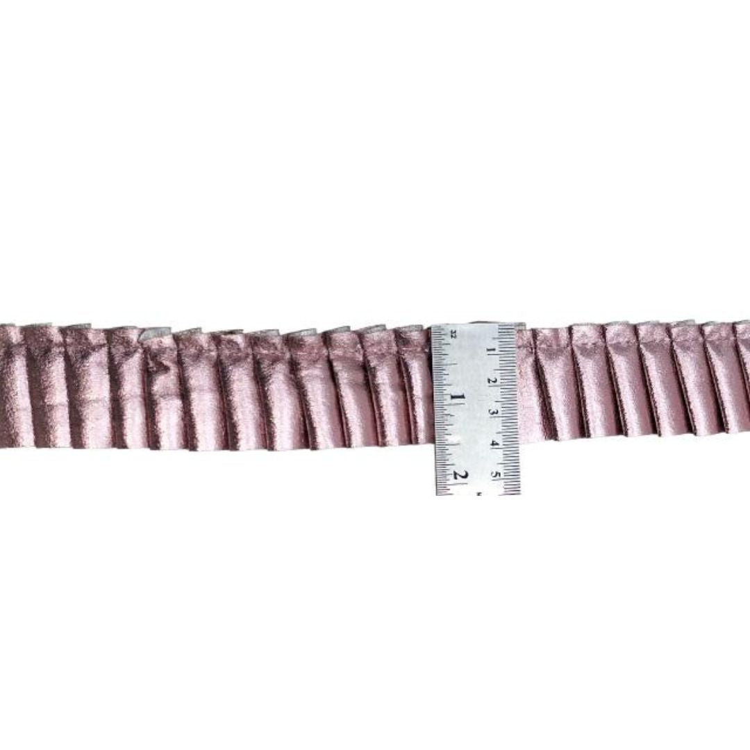 Ruffled fabric trim with a ruler for measurement on a white background