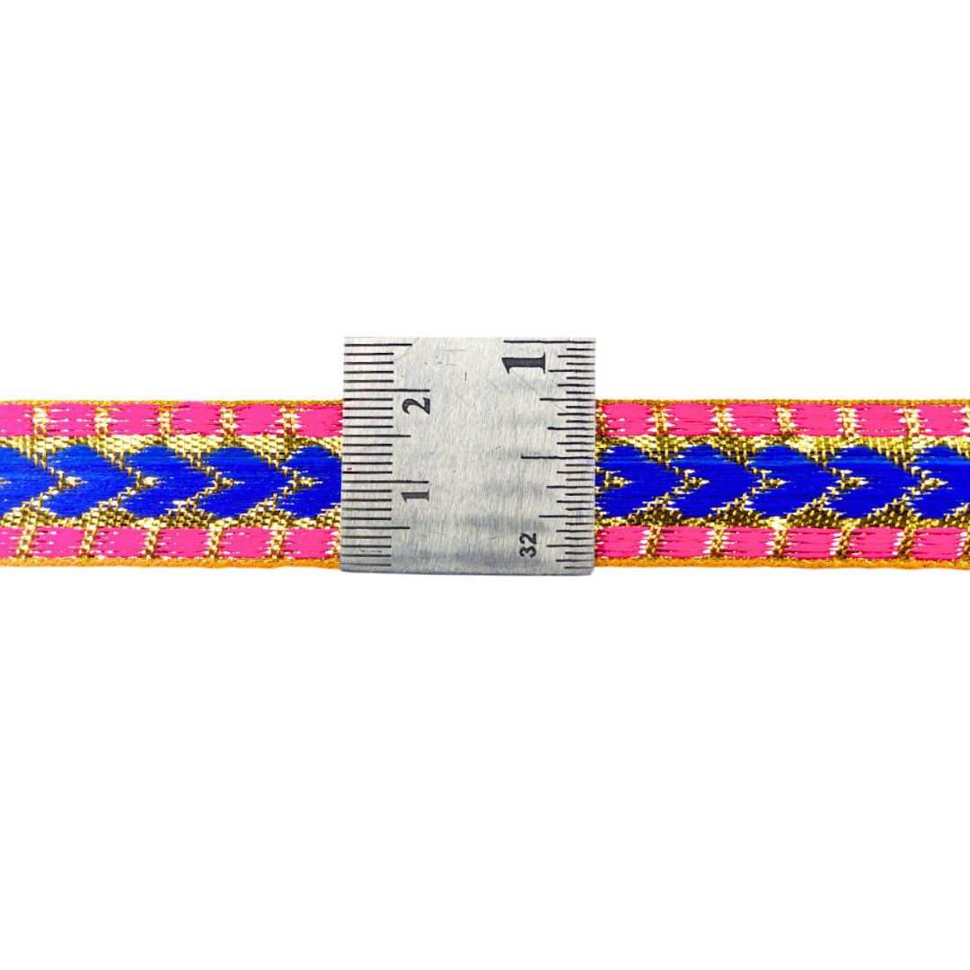 Bracelet with blue and pink pattern and a ruler for size reference on a white background