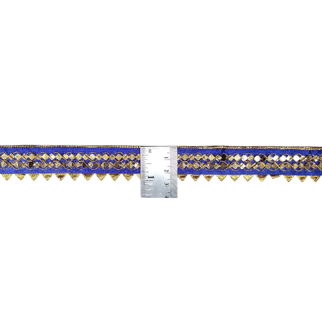 Decorative trim with blue and gold pattern next to a ruler on a white background