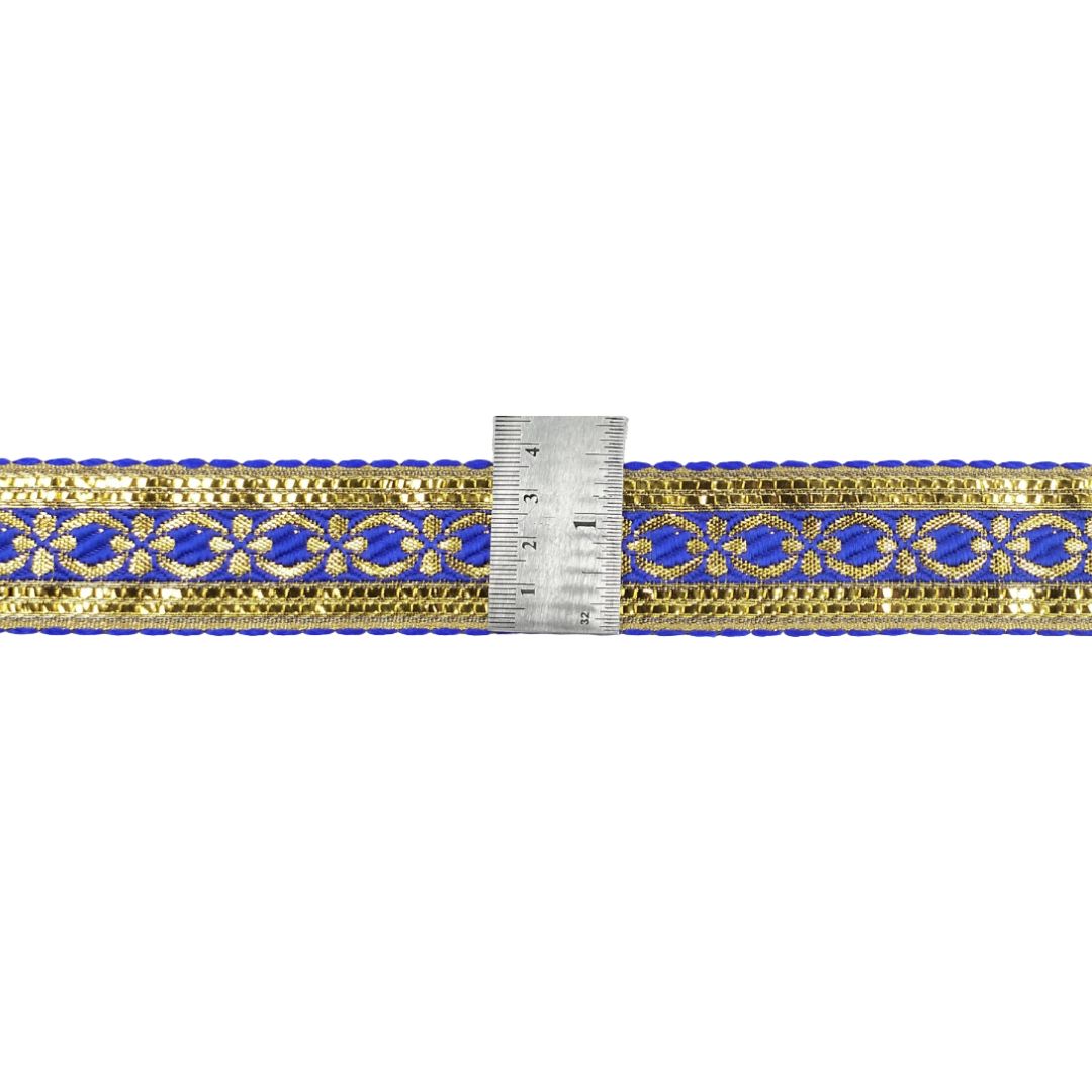 Gold and blue decorative ribbon with a ruler for scale on a white background