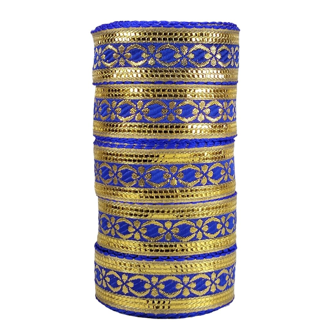 Set of gold and blue bangles stacked on a white background