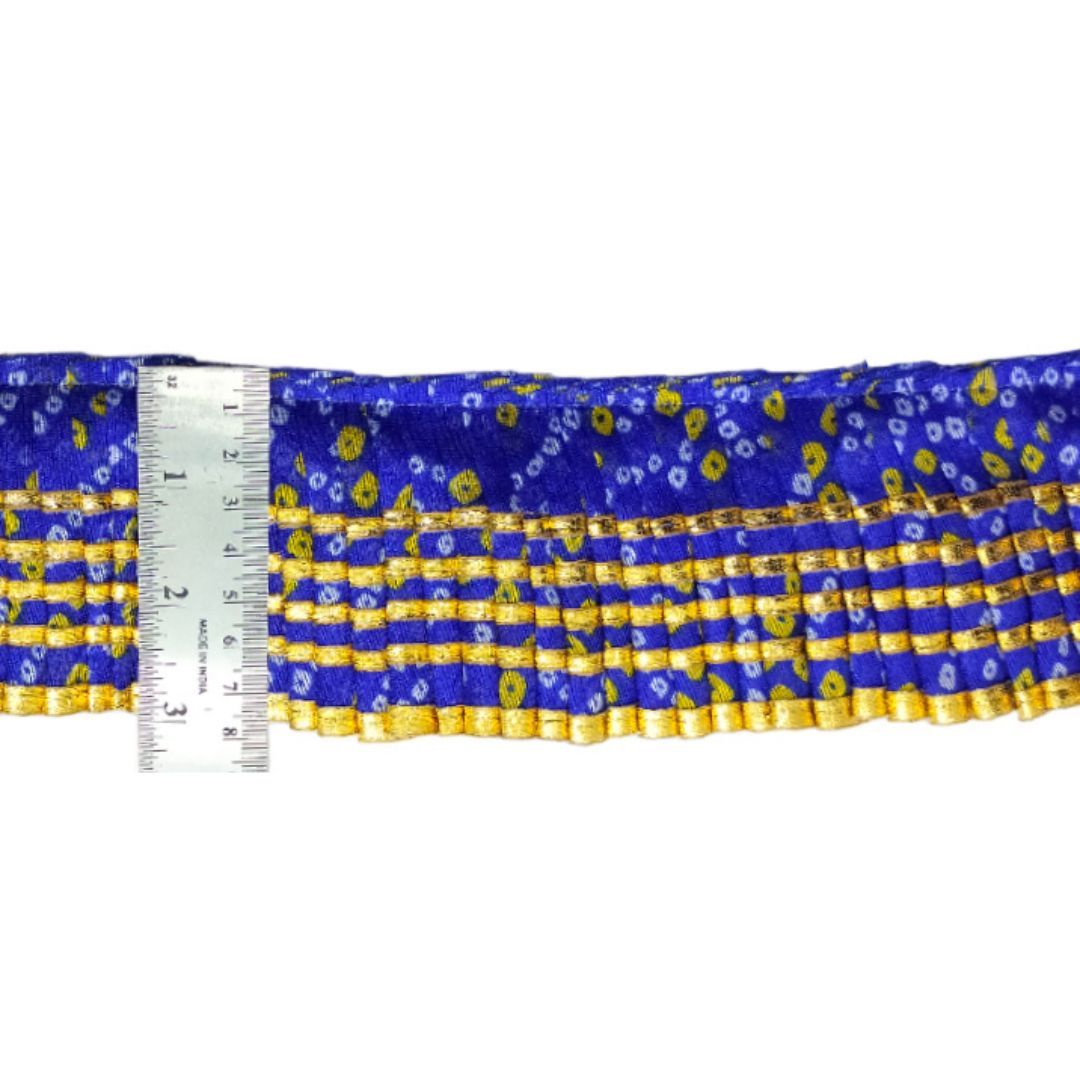 Blue and yellow patterned fabric with a ruler for scale on a white background