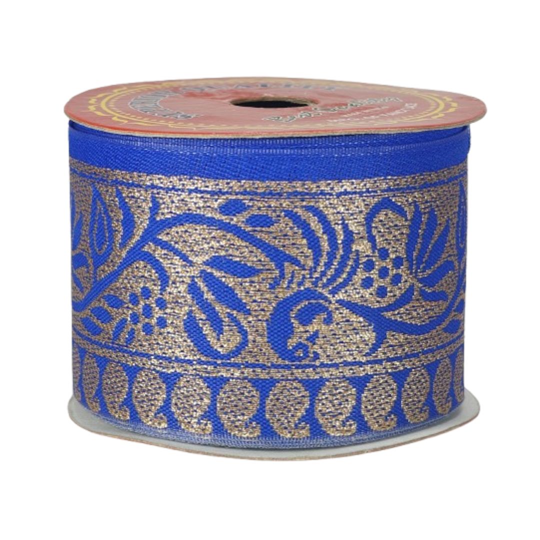 Spool of blue and gold decorative ribbon with floral pattern on a white background