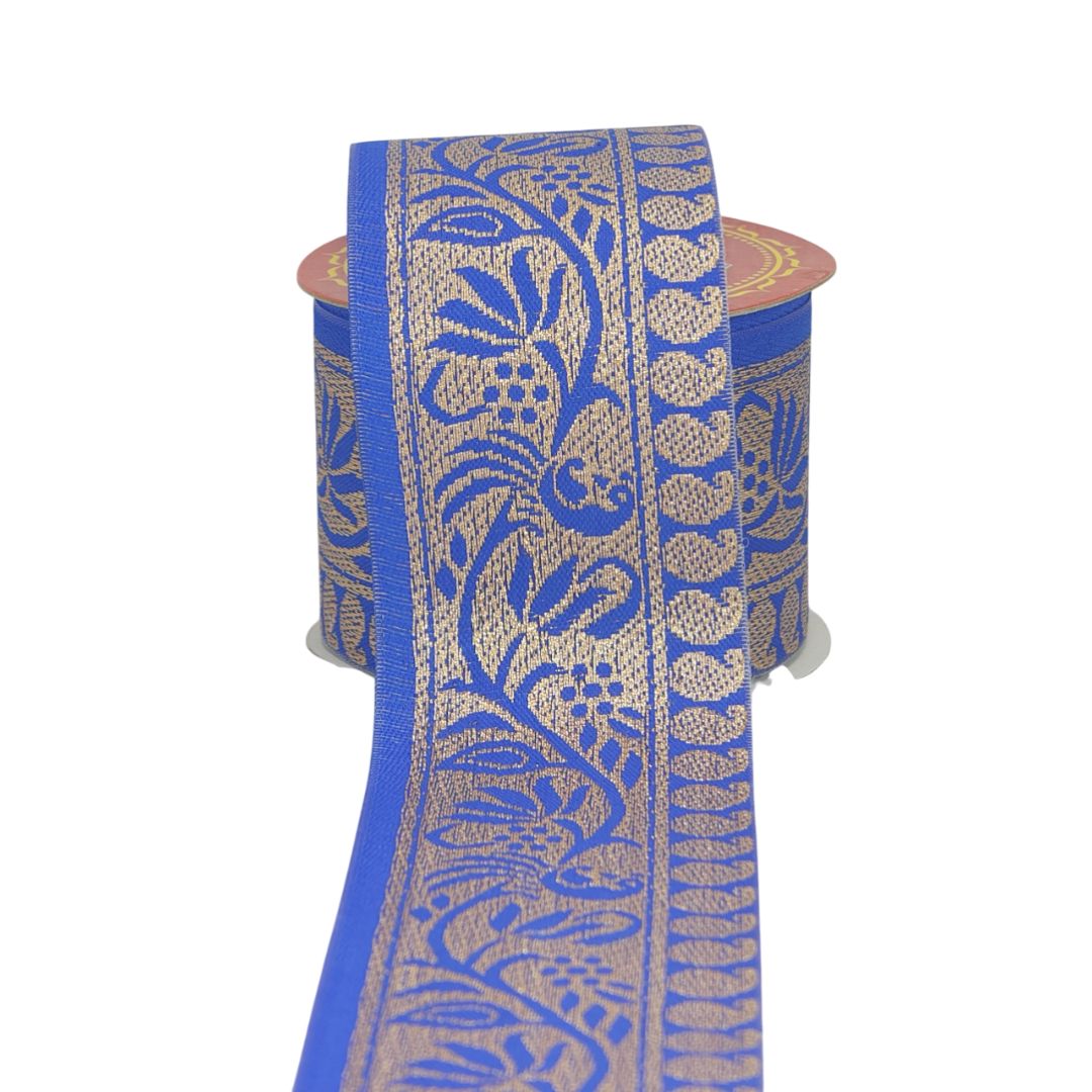 Roll of blue and gold patterned ribbon on a white background