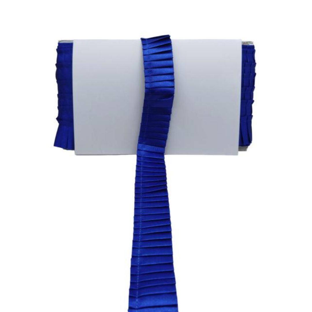 White chair cover with blue ruffled trim on a white background