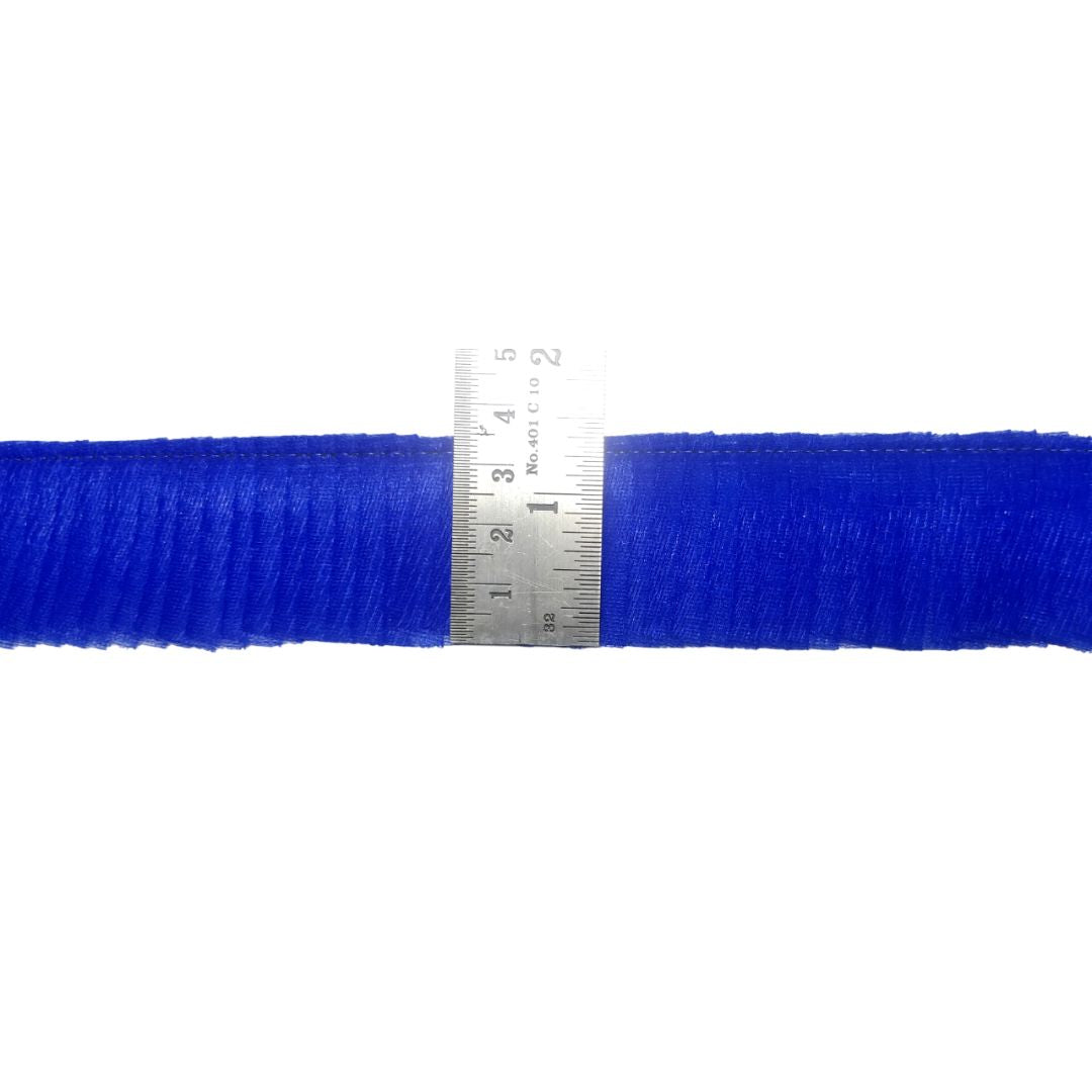 Blue yarn with a ruler for scale on a white background