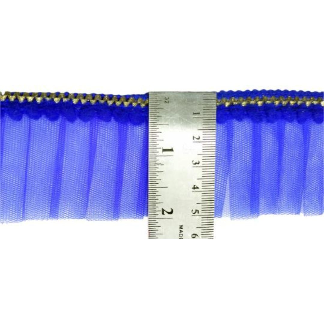 Blue tulle fabric with gold trim measured against a ruler on a white background
