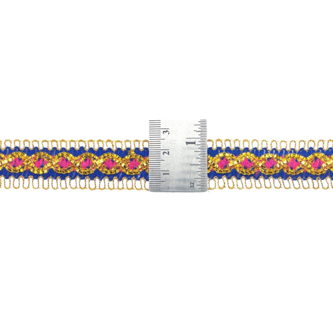 Decorative ribbon with pink and blue pattern next to a ruler on a white background