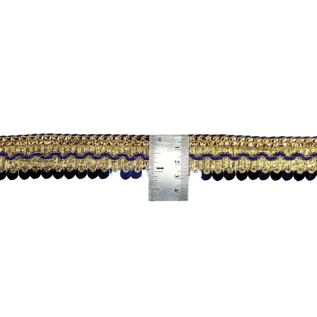 Decorative ribbon with blue and gold pattern next to a ruler on a white background