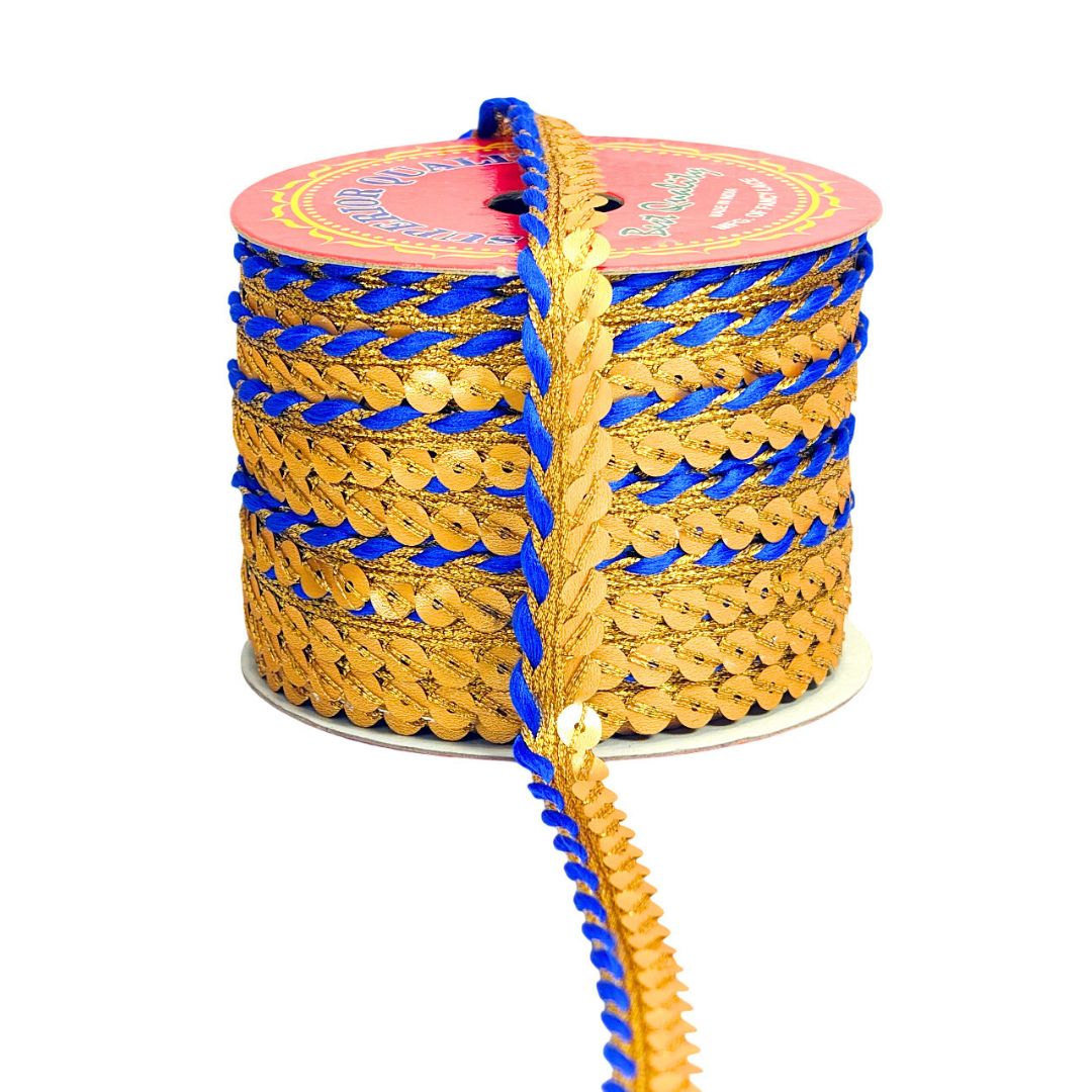 Spool of gold and blue sequin trim on a white background