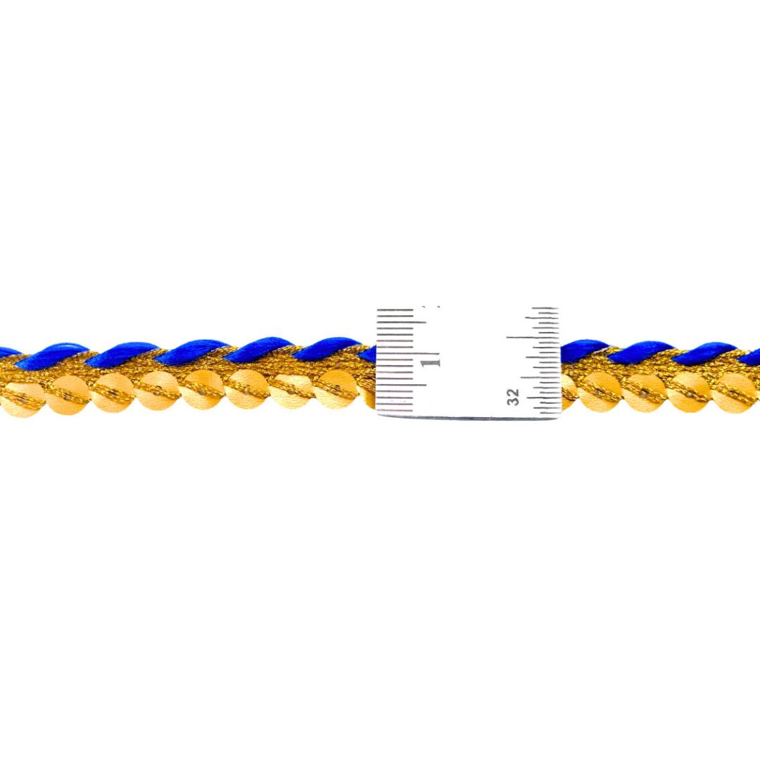 Gold chain with blue accents and a ruler for scale on a white background