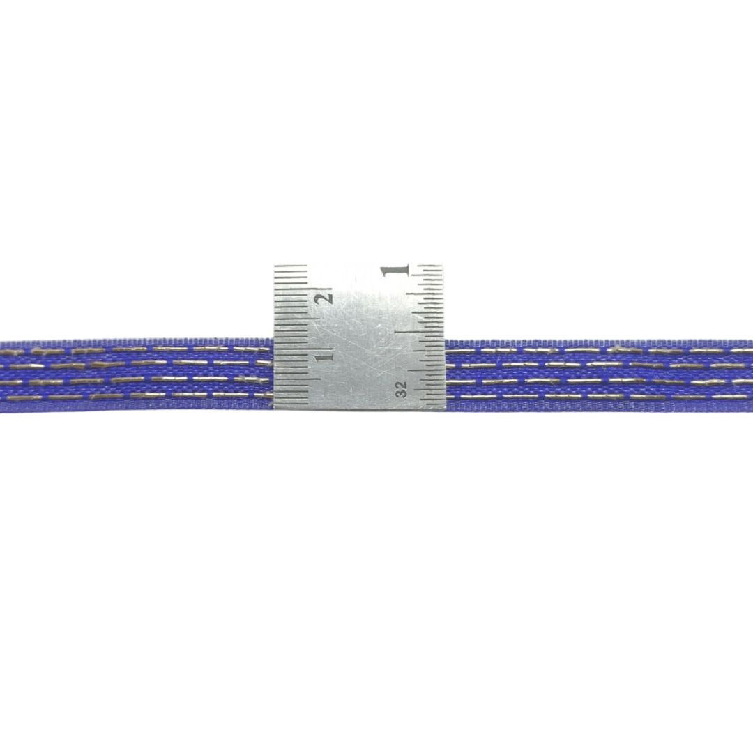 Close-up of a blue and silver ribbed belt with a ruler for scale on a white background