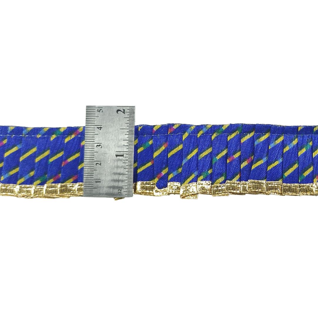 Blue ribbon with yellow and red stripes and a metal ruler for scale on a white background