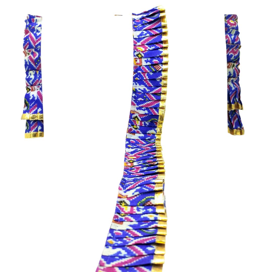 Colorful patterned fabric with gold accents on a white background