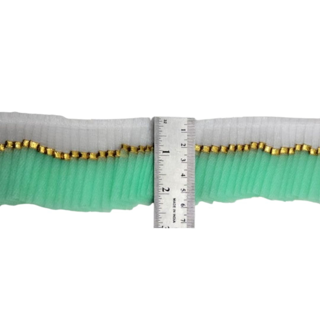 Green belt with gold edges and a ruler for scale on a white background