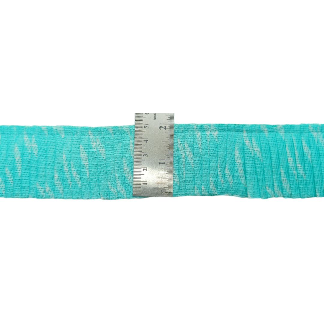 Turquoise webbing with a metal ruler for measurement on a white background