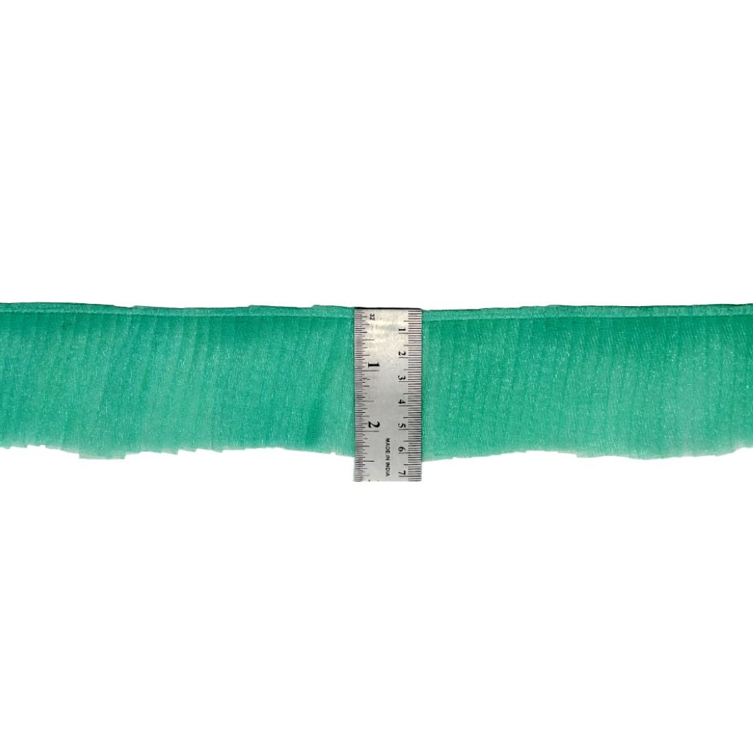 Green ribbon with a ruler for measurement on a white background