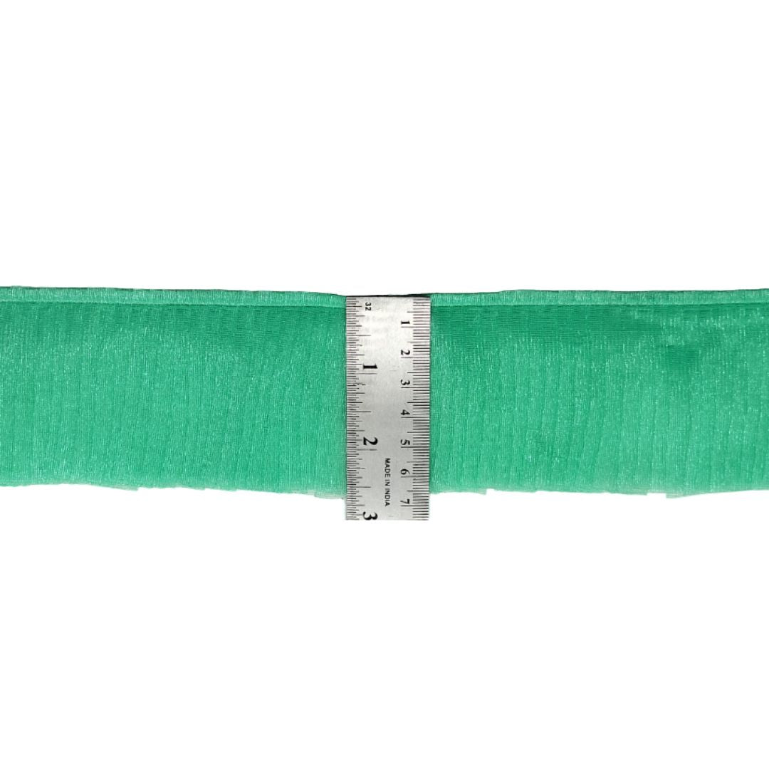 Green ribbon with a ruler for measurement on a white background