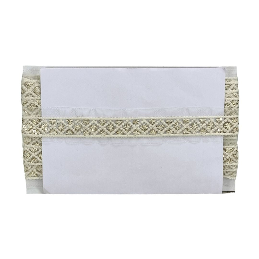 White envelope with decorative gold lace on a white background