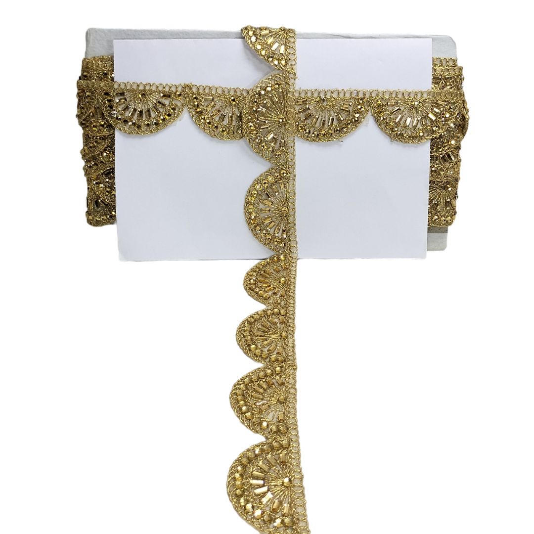 Decorative gold lace ribbon on a white background