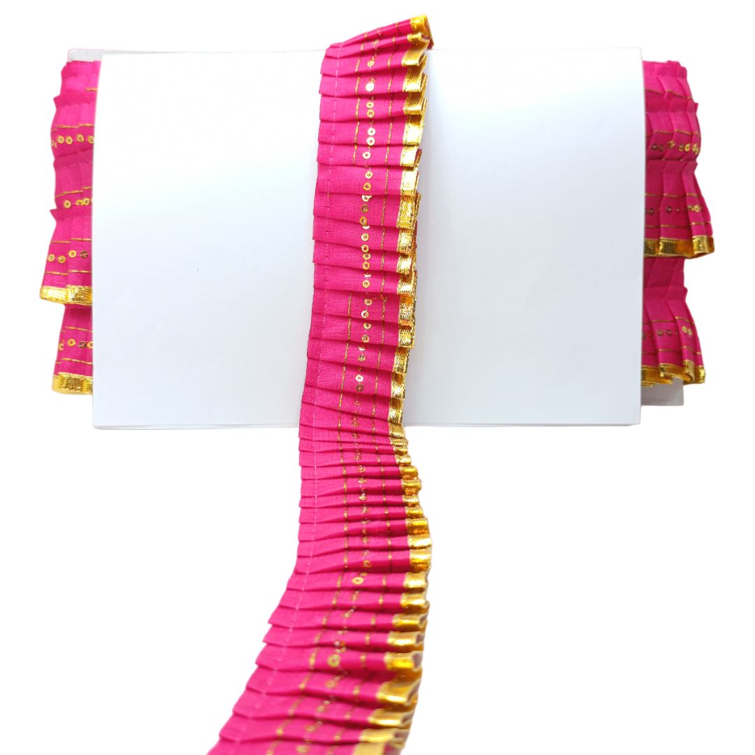 Pink and gold traditional fabric on a white background