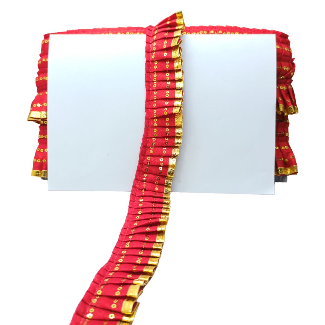 Red fabric with gold patterns on a white background