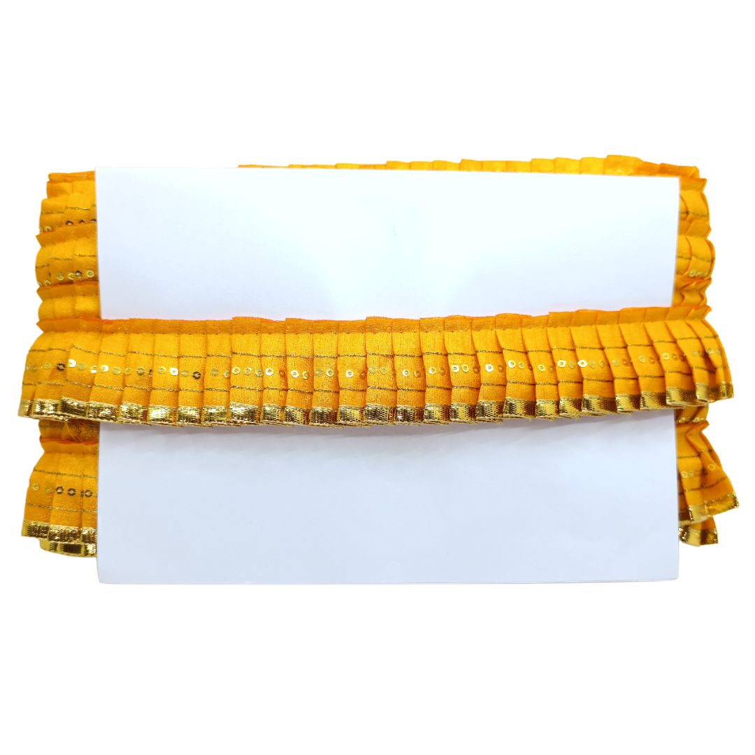 Yellow clutch bag with sequin details on a white background