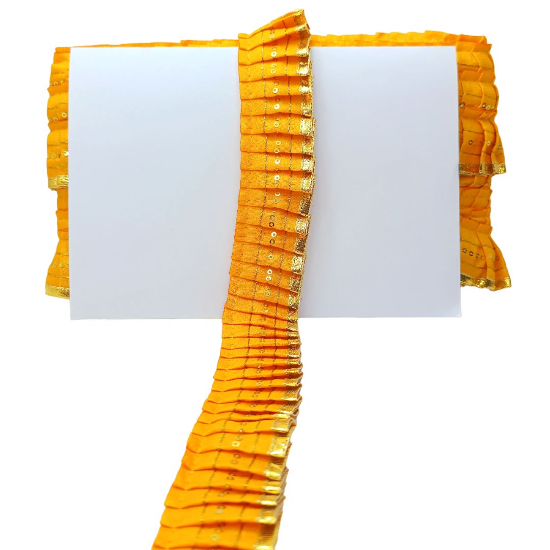 Yellow fabric with ruffled edge on a white background