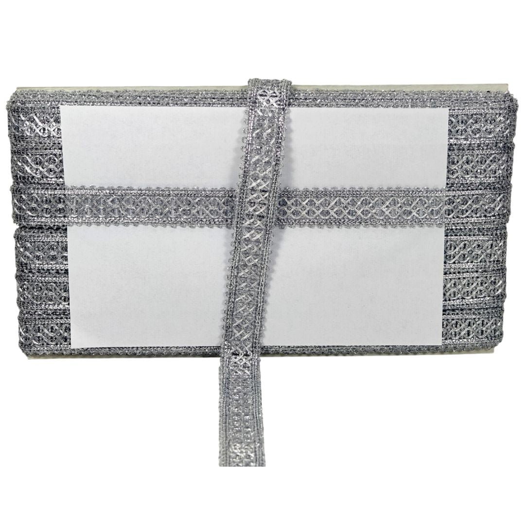 Silver clutch bag with intricate detailing on a white background