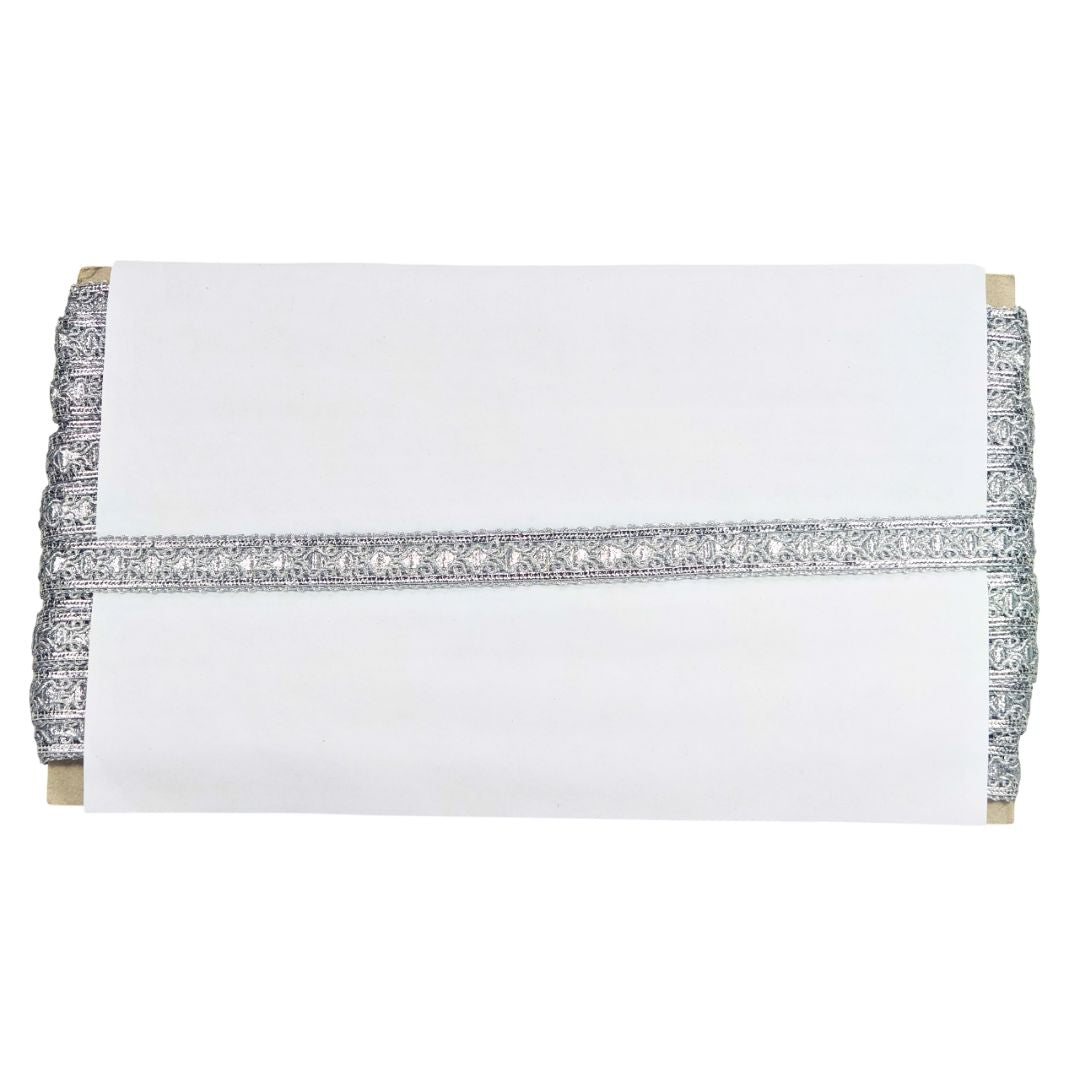 White clutch bag with silver embellishments on a white background