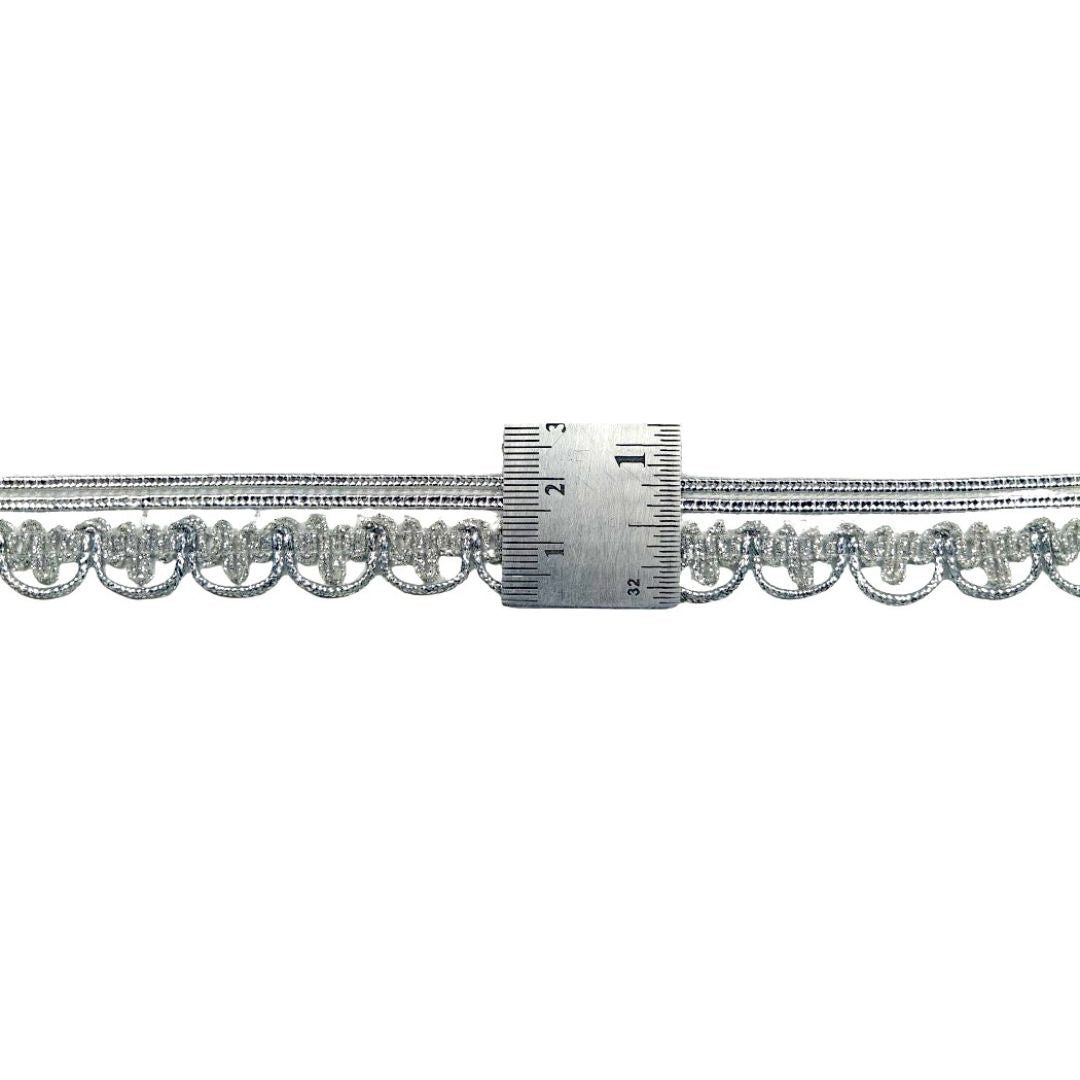 Silver chain with a ruler for scale on a white background