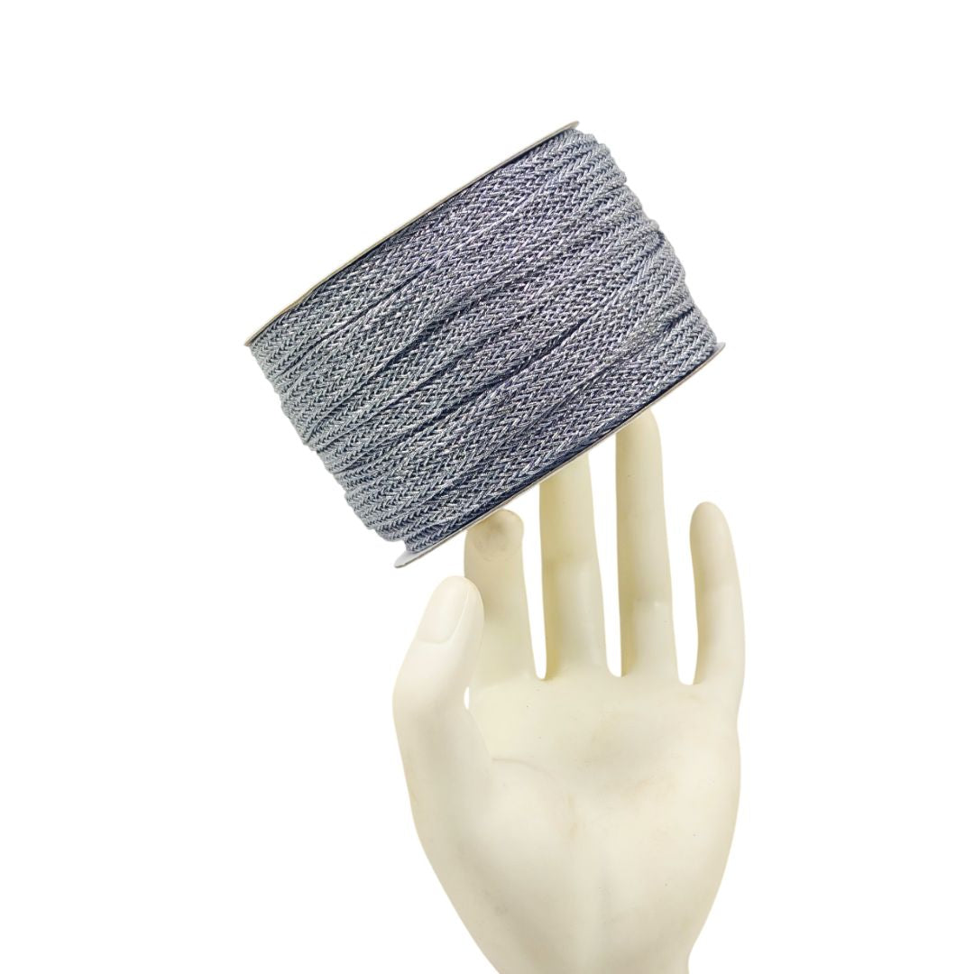Textured headband on a mannequin hand against a white background