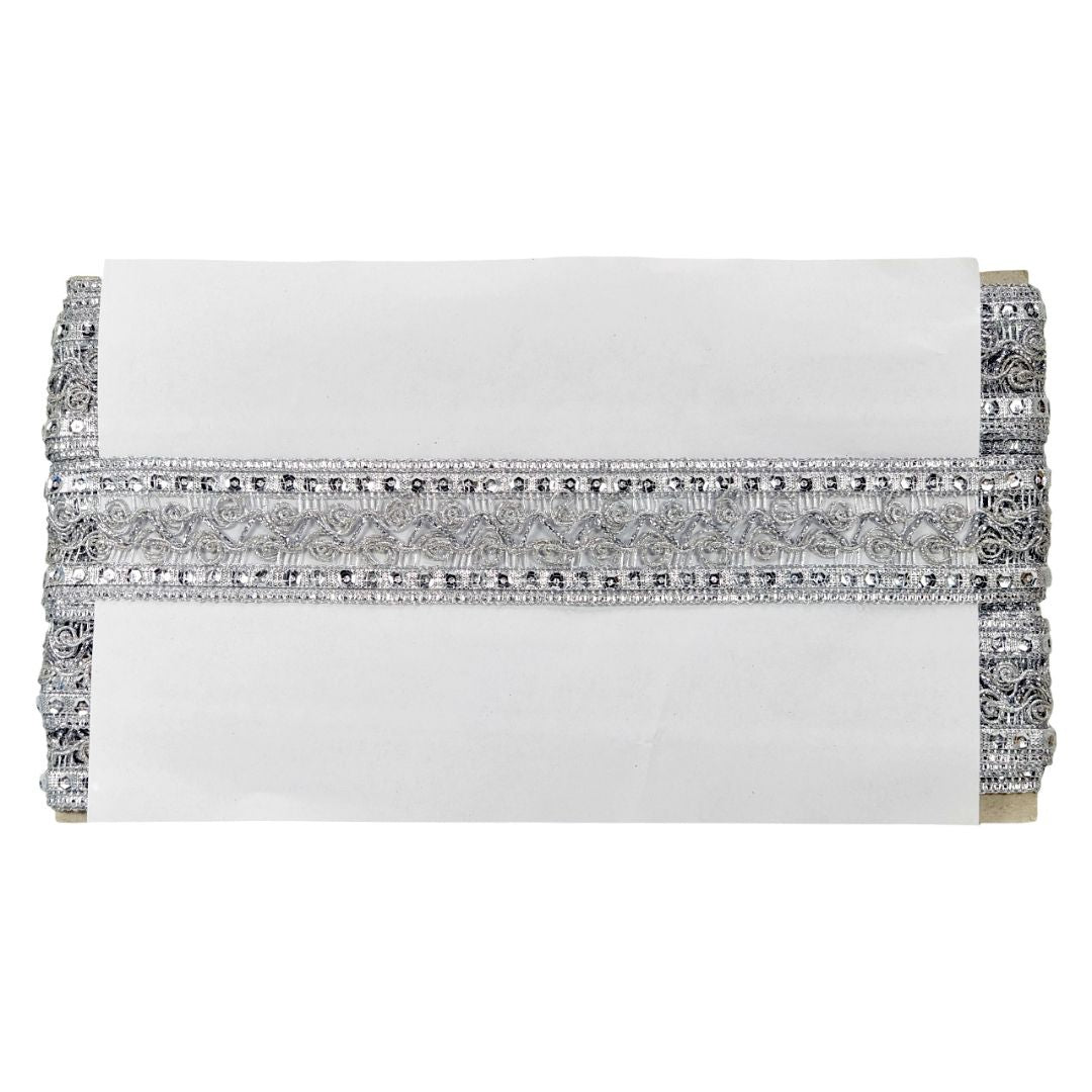 White clutch with silver embellishments on a white background