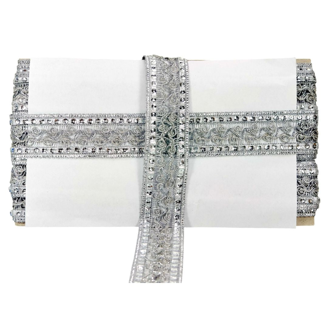 White clutch with silver beaded detailing on a white background