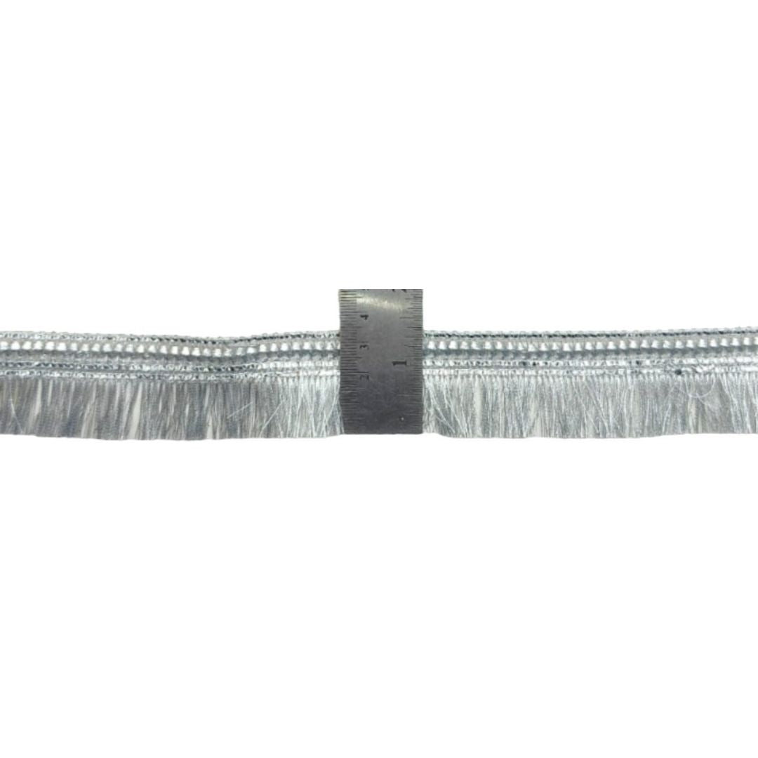 Close-up of a metallic strip with a ruler for scale on a white background