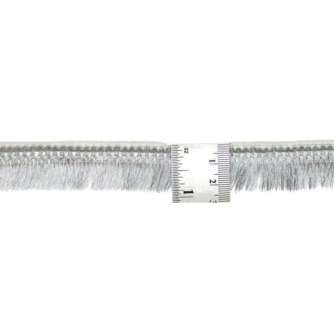 Metallic fringe trim with a ruler for measurement on a white background