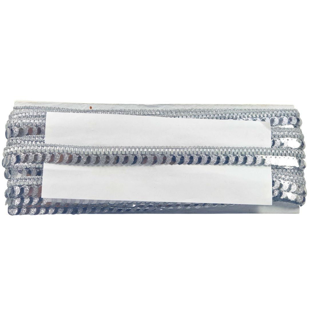 White rectangular object with blue and silver decorative trim on a white background