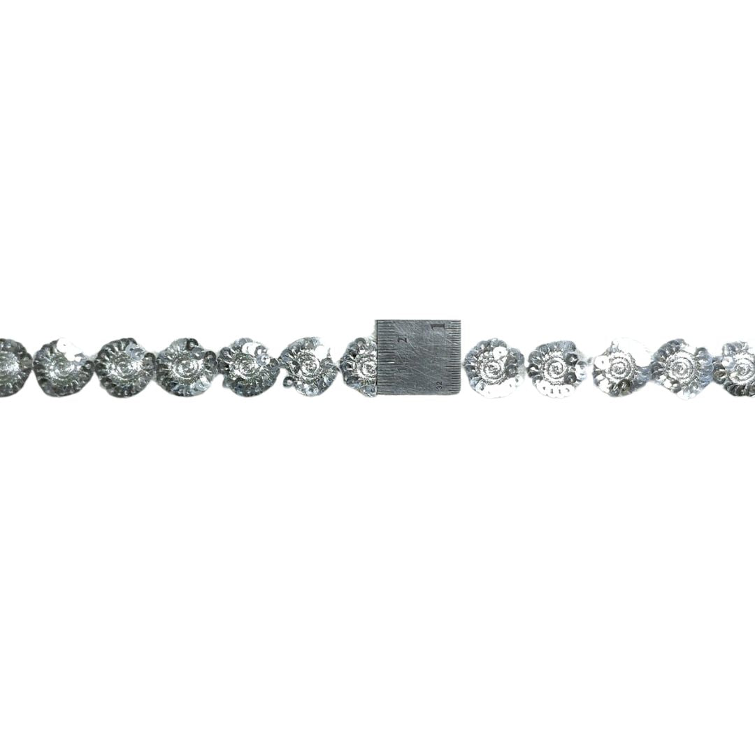 Silver bracelet with floral designs on a white background