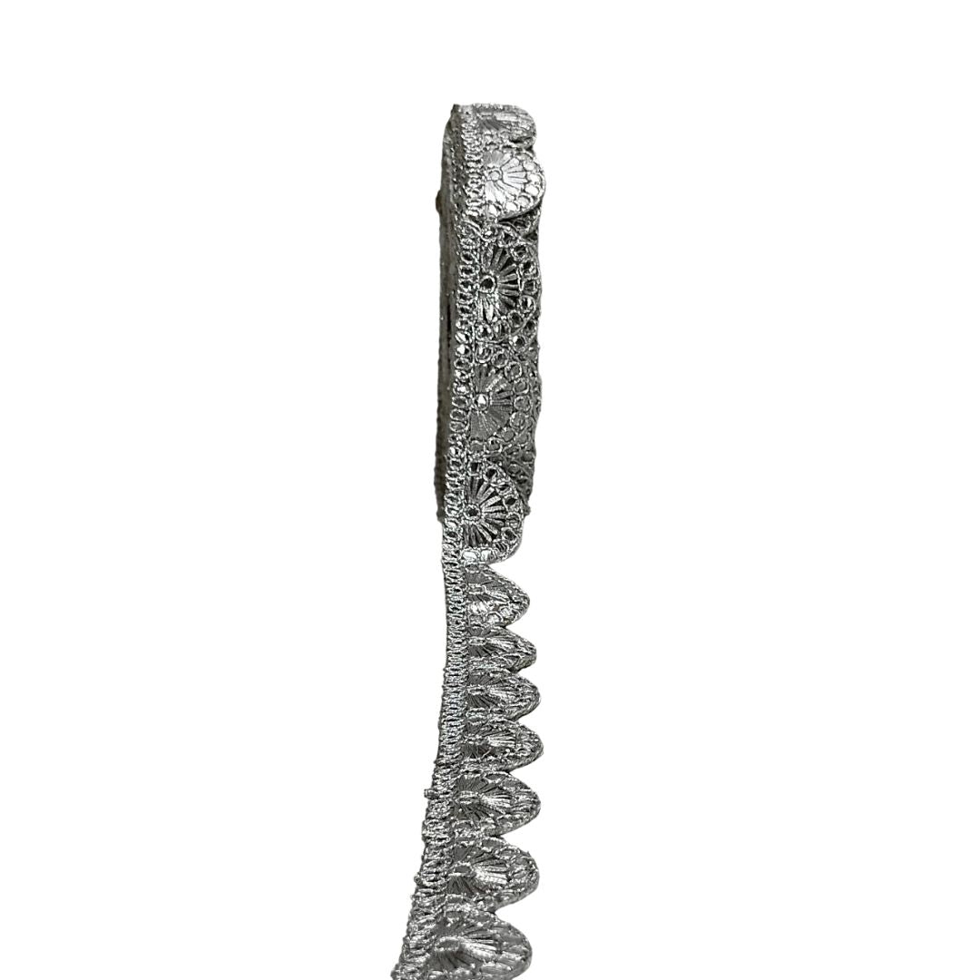 Silver bracelet with intricate design on a white background