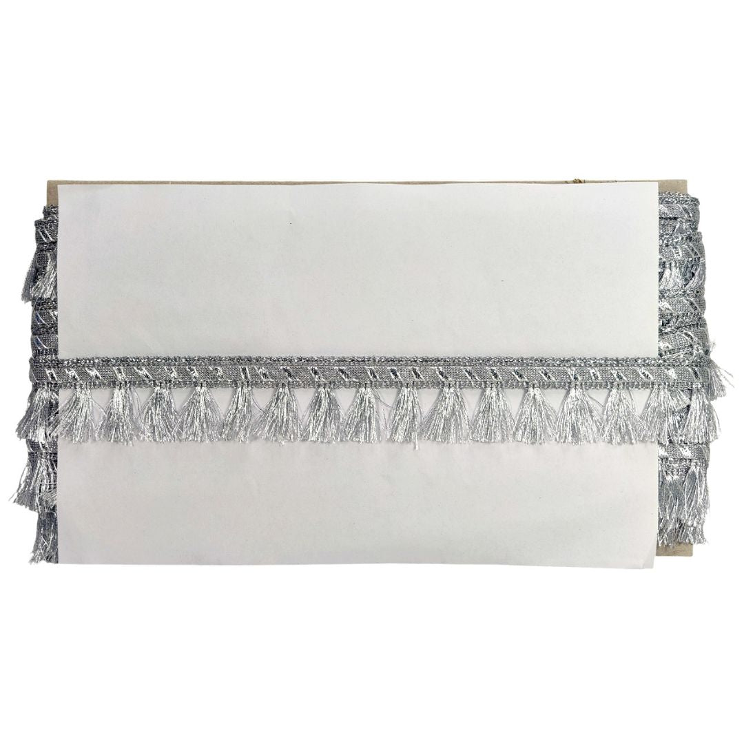 White clutch with silver fringe on a white background