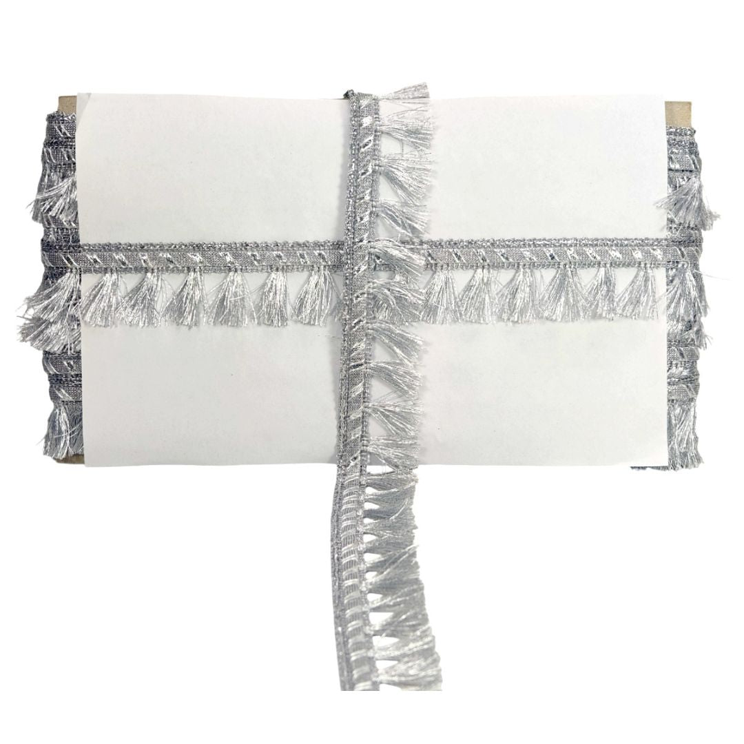 White clutch with silver tinsel fringe on a white background