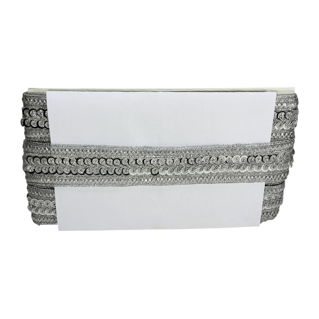 White clutch with silver embellishments on a white background
