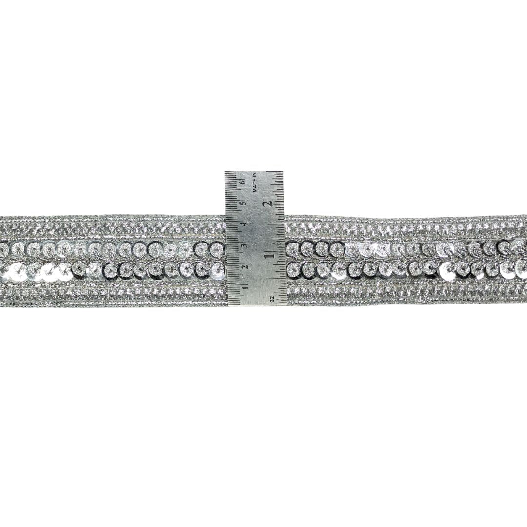 Silver rhinestone belt with a ruler for scale on a white background
