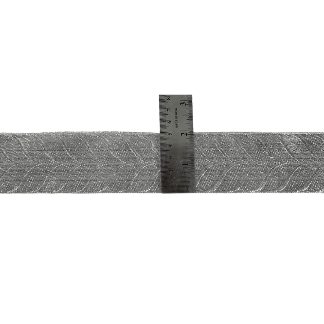 Metallic tape with a ruler showing measurements on a white background