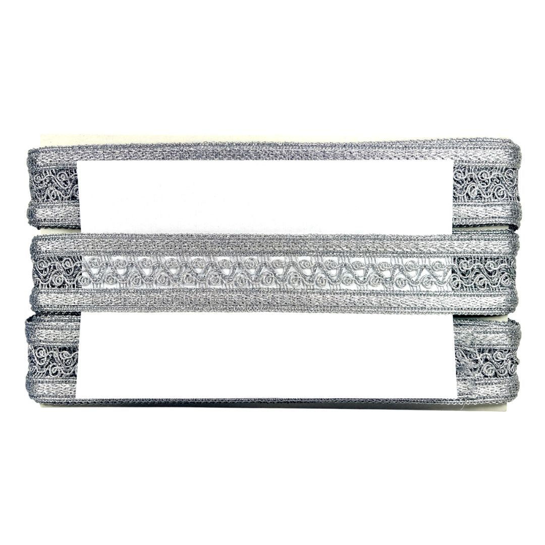 Decorative silver belt with intricate patterns on a white background