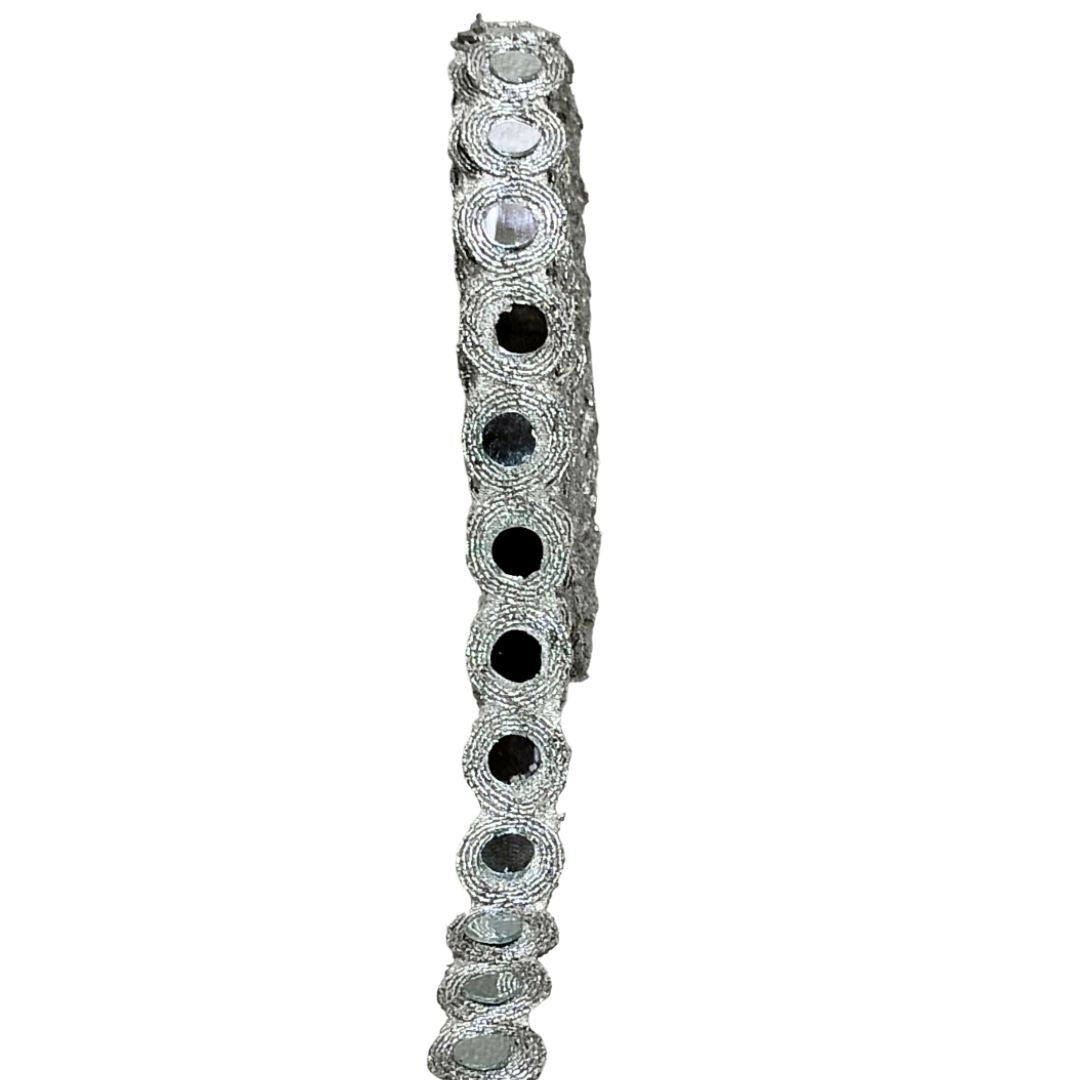 Silver bracelet with black and clear gemstones on a white background