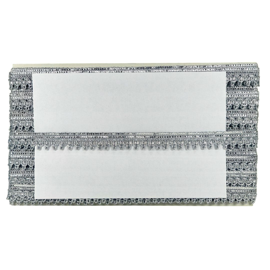 Silver clutch with decorative patterns on a white background