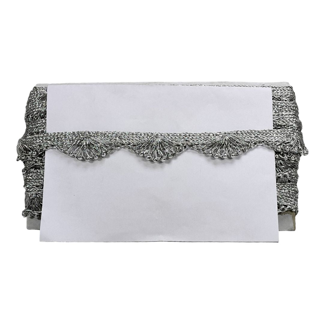 White clutch with silver embellishments on a white background