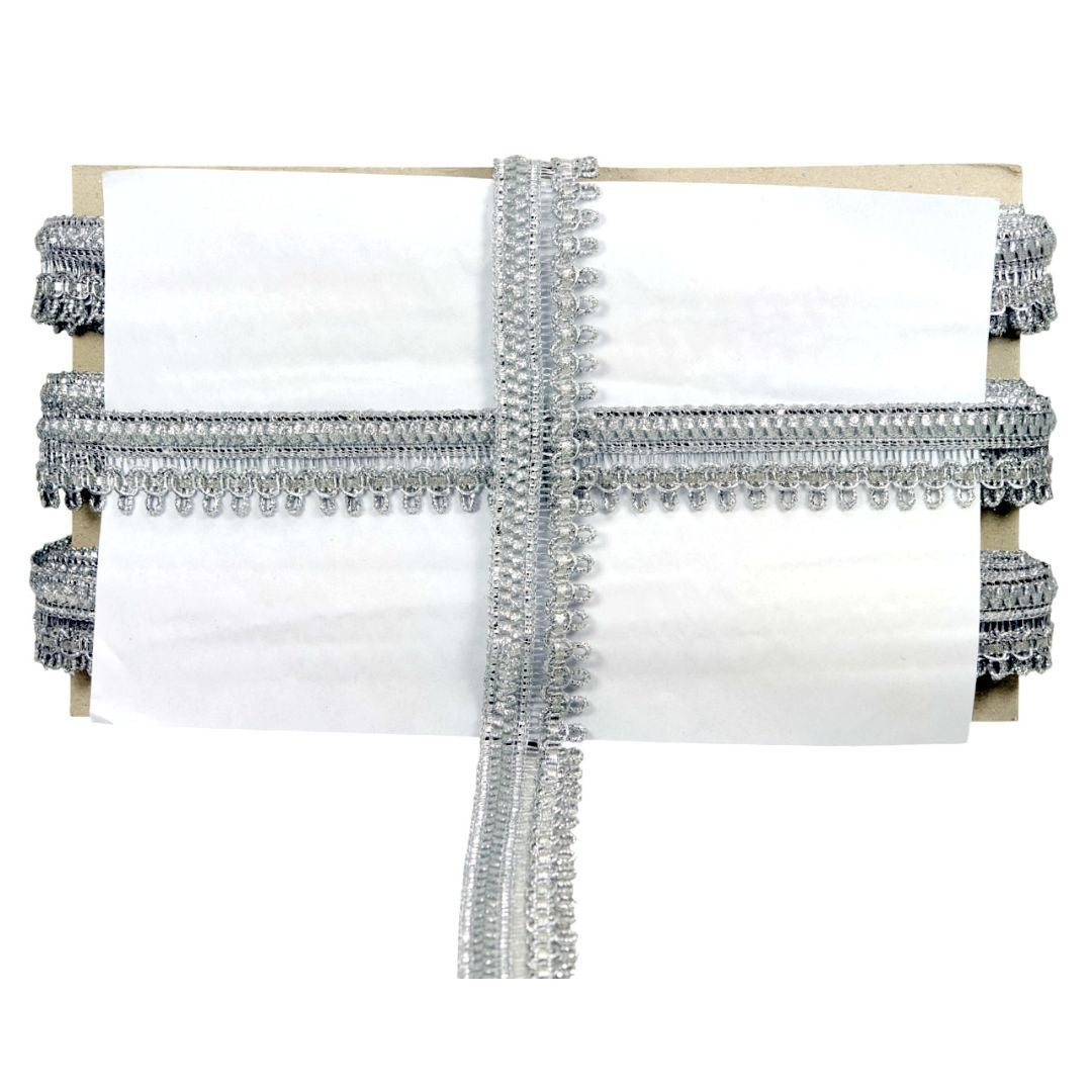 Decorative headboard with silver fringe on a white background