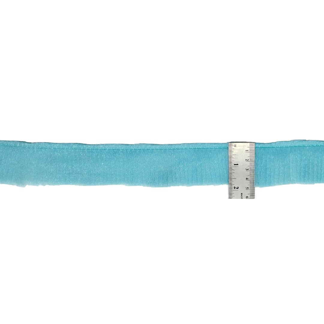 Turquoise ribbon with a ruler for measurement on a white background